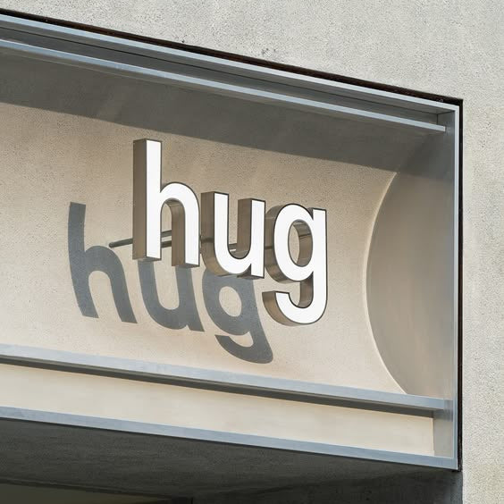 Custom 3D acrylic letter sign mounted on a modern storefront façade, creating a clean and professional brand display.