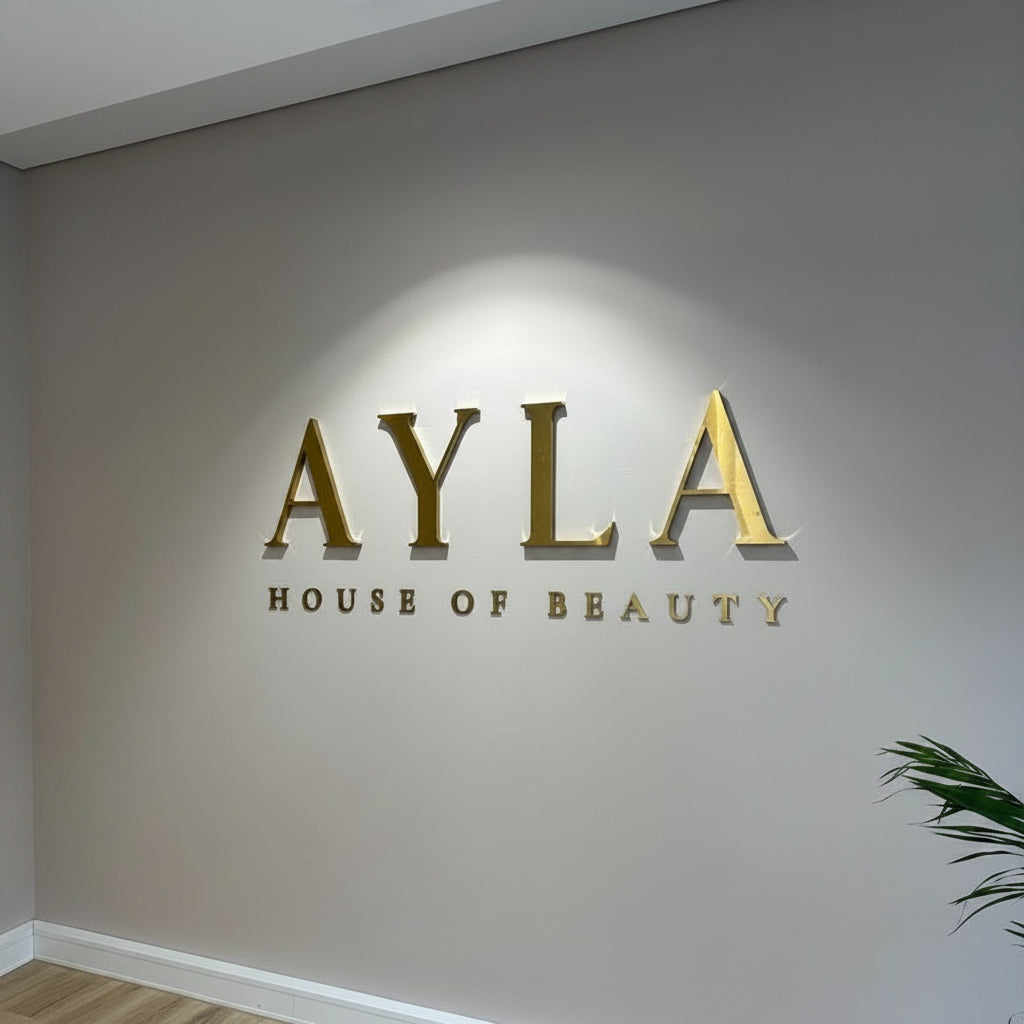 Luxury gold stainless steel 3D letters mounted on a premium salon reception wall