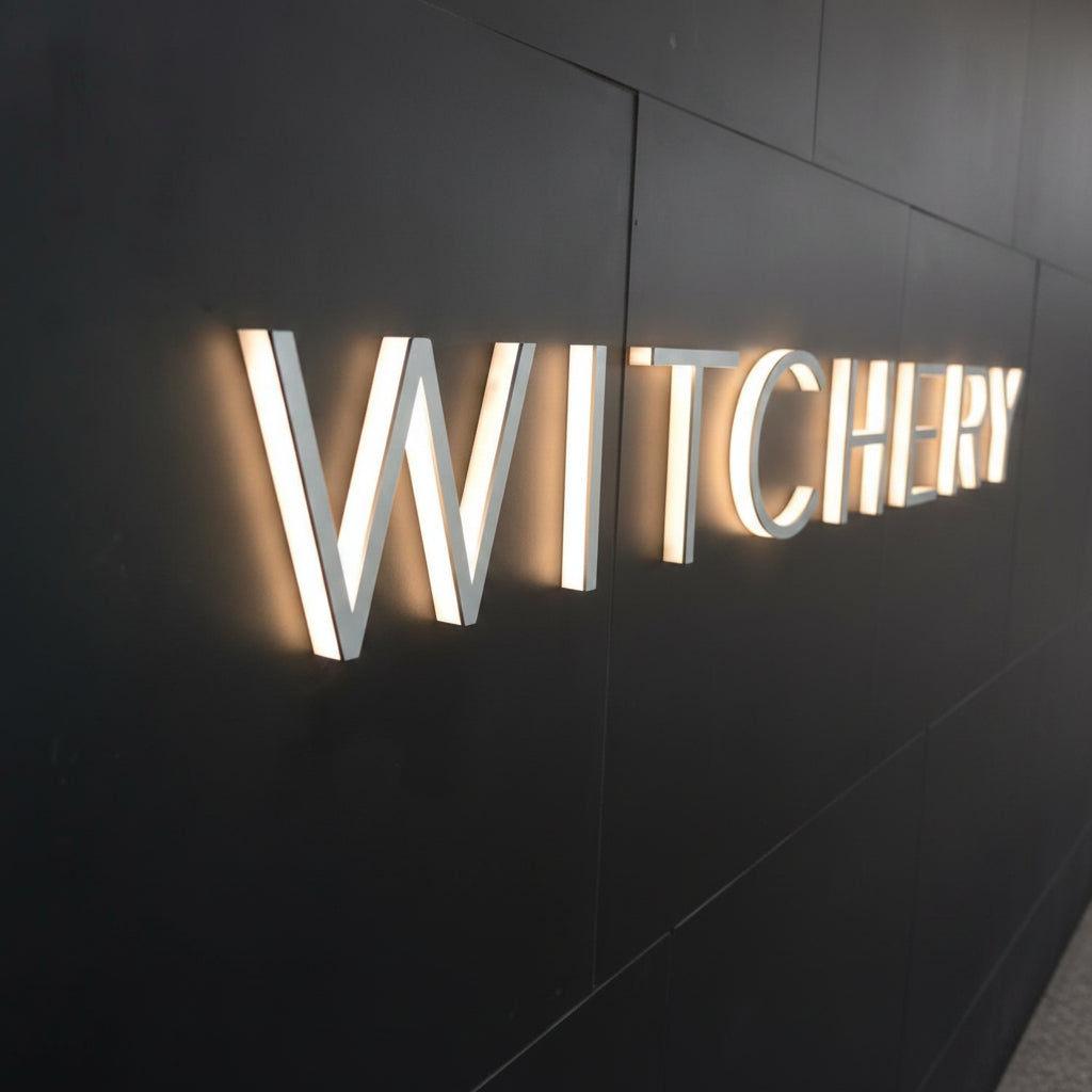 Modern custom LED channel letter sign with illuminated 3D letters mounted on a dark wall, ideal for office reception, retail stores, hotels, and business branding.