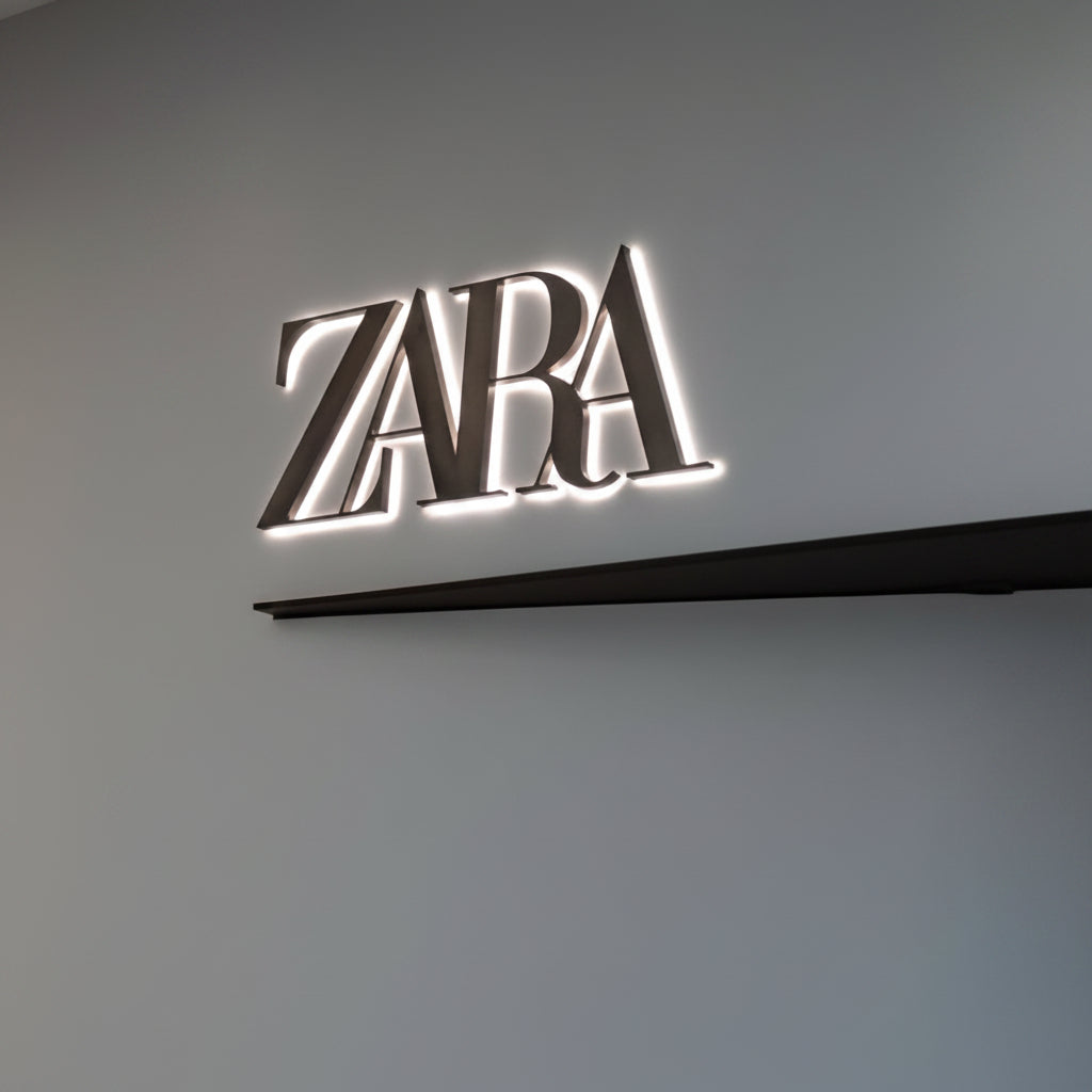 Modern illuminated Zara logo wall art featuring a luxury fashion-inspired minimalist design on a gray wall.