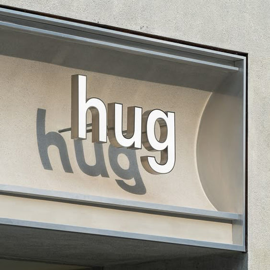 Custom 3D acrylic letter sign mounted on a modern storefront façade, creating a clean and professional brand display.