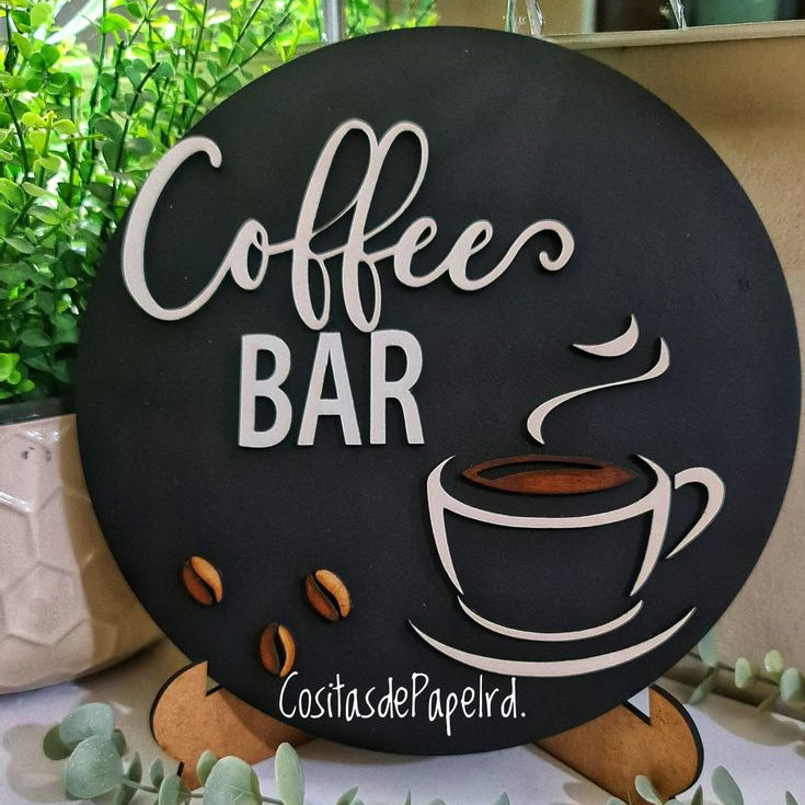 Black circular café sign featuring white acrylic lettering and steaming coffee cup artwork
