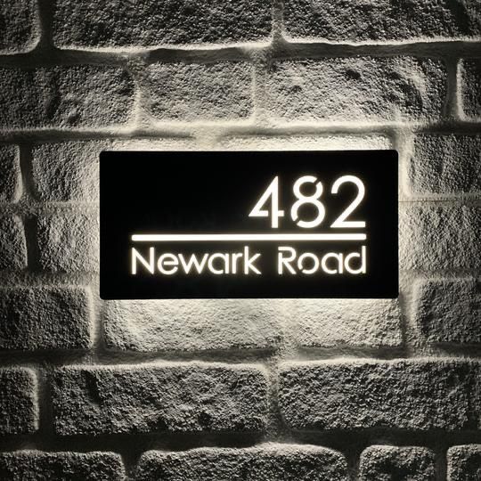 Modern illuminated backlit address sign with personalized house number and street name