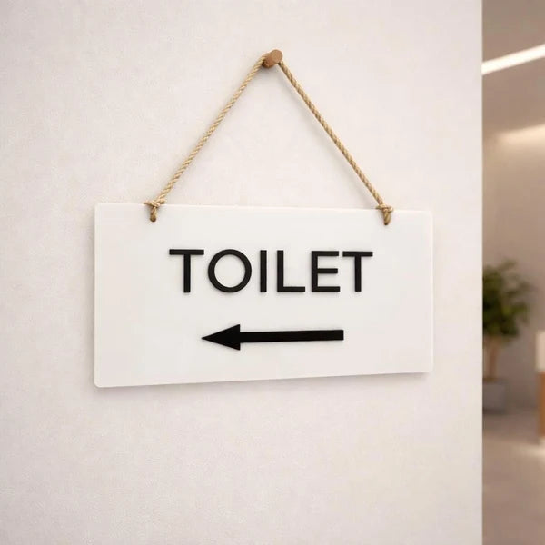 Modern toilet wayfinding neon sign with left-pointing arrow for offices, hotels, and public spaces.