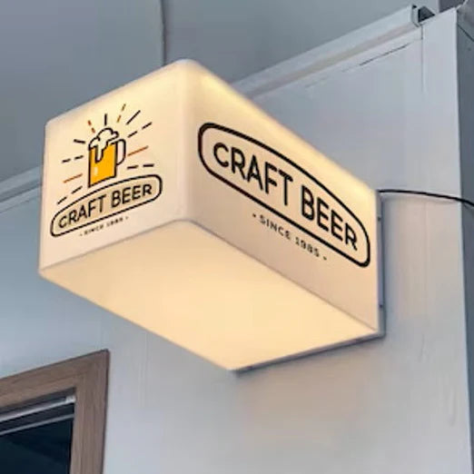 Wall-mounted acrylic cube light box displaying custom business logo for a café or brewery.