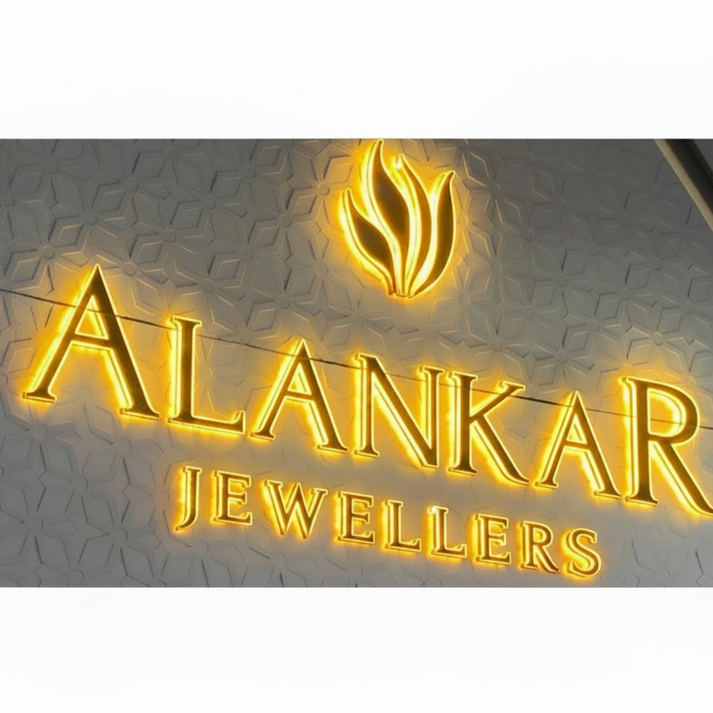 Custom gold LED halo-lit channel letter sign with warm illuminated lettering for a luxury jewellery showroom.