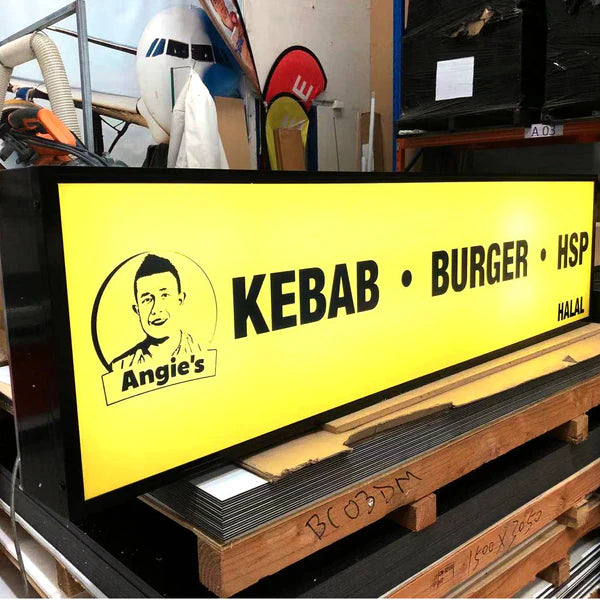Large rectangular acrylic LED display board with custom food branding for commercial storefronts.