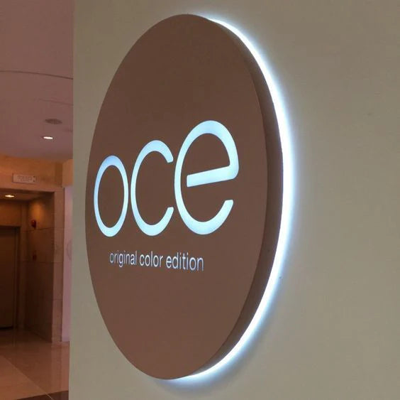 Circular backlit acrylic business sign featuring elegant halo lighting for corporate branding.