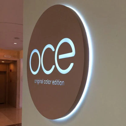 Circular backlit acrylic business sign featuring elegant halo lighting for corporate branding.