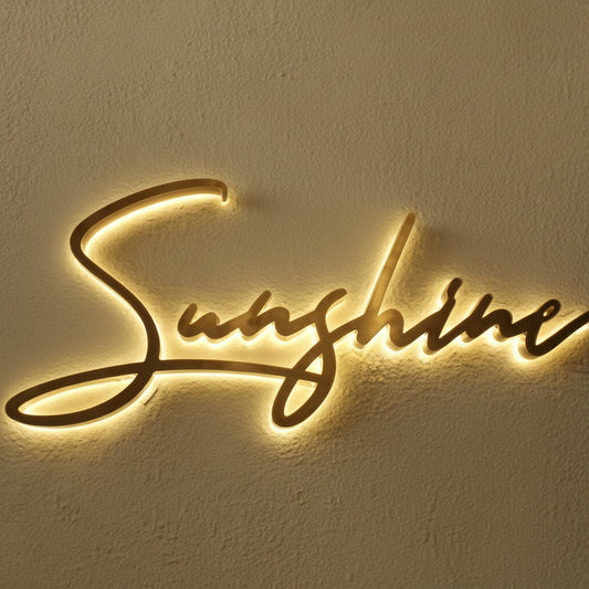 Custom warm white LED script name sign mounted on a wall, featuring elegant cursive lettering with a soft illuminated glow.