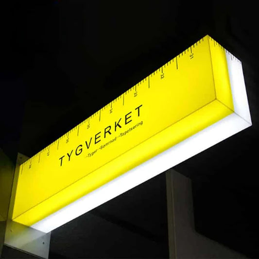 Modern illuminated rectangular storefront sign with ruler design and custom branding.