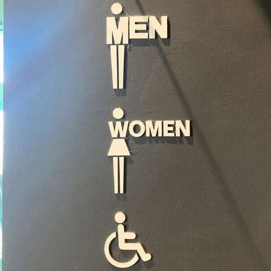 Custom accessible restroom neon sign with male, female, and wheelchair symbols for public spaces.