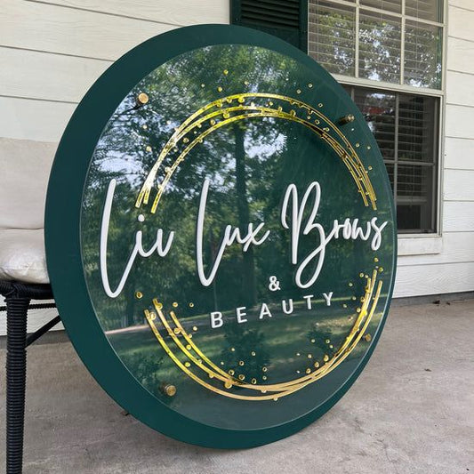 Elegant round beauty salon branding sign featuring layered acrylic lettering and emerald green frame