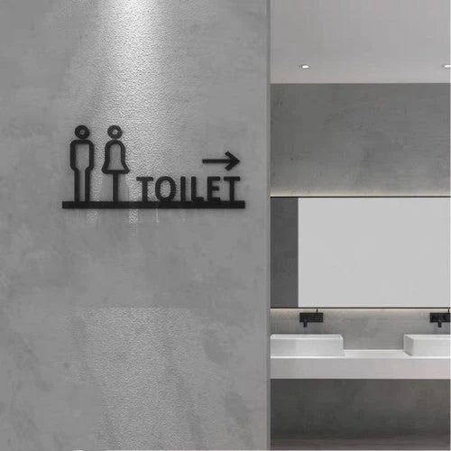 Custom restroom wayfinding neon sign with toilet text and directional arrow for commercial interiors.