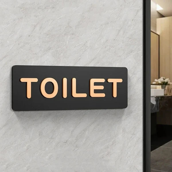 Custom acrylic restroom wayfinding sign with warm LED lighting for public facilities.