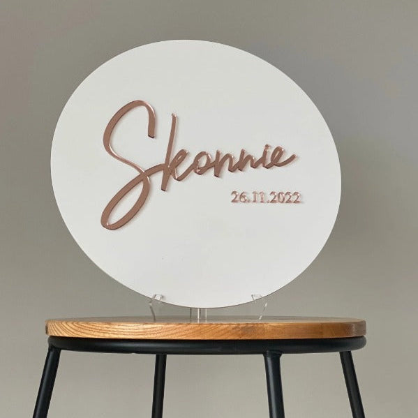 Elegant white circular welcome sign featuring custom event name and date display