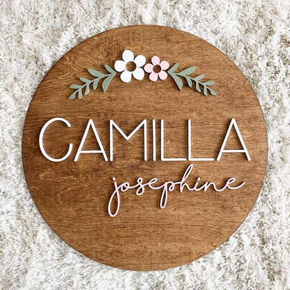 Round nursery name plaque featuring custom baby name on natural wood background