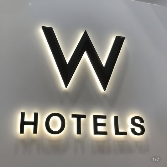 Premium custom halo-lit hotel logo sign with LED backlit 3D letters mounted on an interior wall, ideal for hotels, offices, and luxury commercial branding.