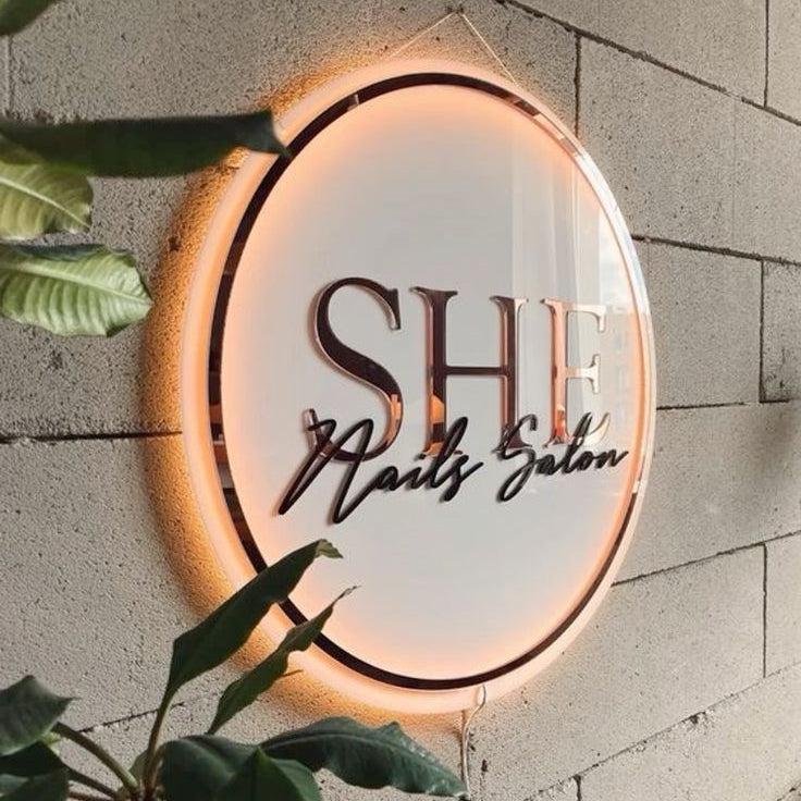 Custom beauty salon branding sign featuring elegant acrylic lettering and soft glow